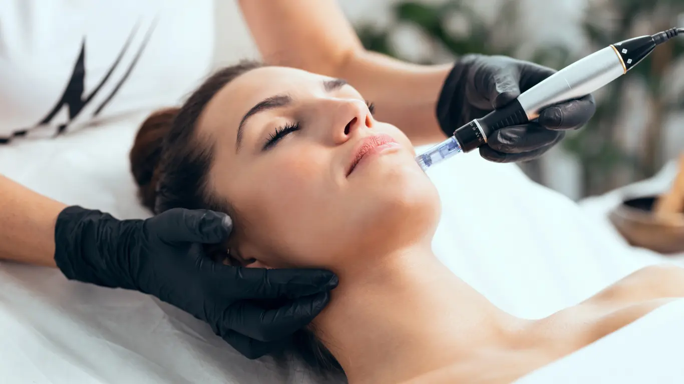 Client receiving a facial massage with a vibrating tool