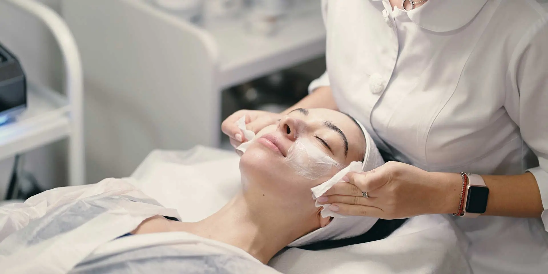 Aesthetician using a magnifying lamp during facial examination