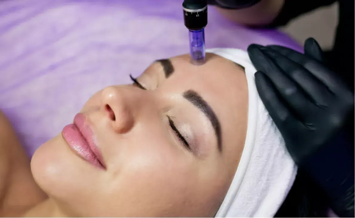 Woman lying down after facial treatment, wearing a headband